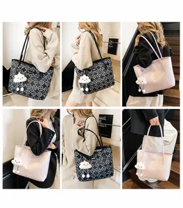 Detail of ethnic geometric tote bags with cloud pendant charms on a female model