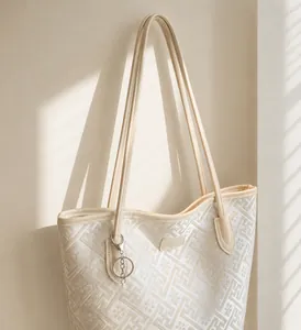 Close-up of geometric jacquard tote bag with elegant silver logo and metal ring detail