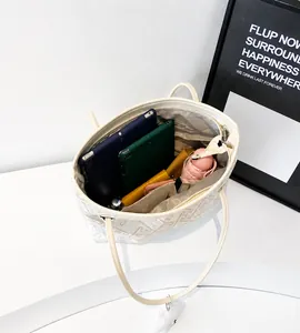 Top view of open tote bag showing large capacity with tablets, umbrella and wallet inside