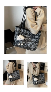 Close-up of geometric pattern tote bag with plush cloud charm and metal logo detail