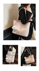 Detailed view of pink patterned tote bag with soft cloud pendant and TUCANO logo