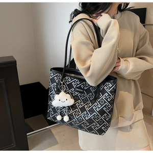 Ethnic style tote bag with geometric pattern and white cloud plush charm on model