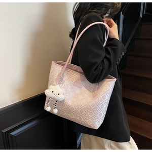 Detail of light pink tote bag with floral patterns and a cute white cloud pendant charm