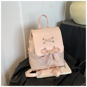 Detail eines rosa Kunstleder-Rucksacks mit Schnürschleife und Klappverschluss