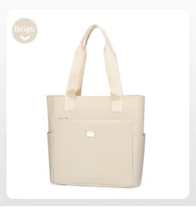 Macro detail of beige tote bag showing high-quality canvas texture and front zipper pocket