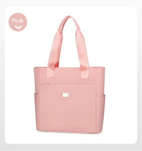 Detailed view of pink Oxford tote bag with front zipper pocket and side compartments