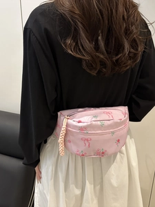 Pink floral fanny pack for women featuring rose patterns and a bow with woven pendant