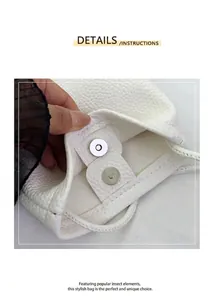 Detail of the silver magnetic snap closure on a white lychee grain leather crossbody bag