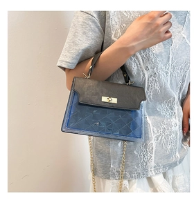 Detail of blue PVC crossbody bag with grey leather flap and gold chain strap