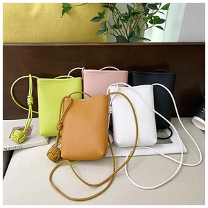 Close-up of mini leather bucket bags in five colors with knotted shoulder straps