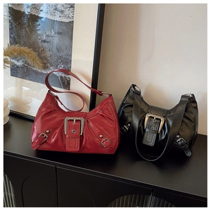 Detailed view of vintage aesthetic faux leather hobo bags with large silver buckles