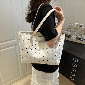 Chic white large capacity tote bag with 3D pleated texture and delicate black bow patterns