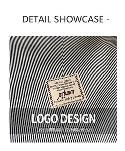 Close-up of black and white striped fabric detail with stitched rectangular brand label