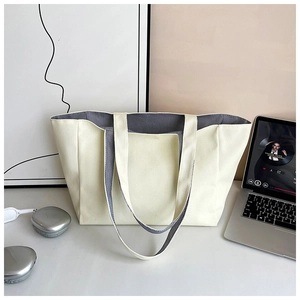 Detail showing the inner grey striped lining and spacious interior of the canvas tote bag