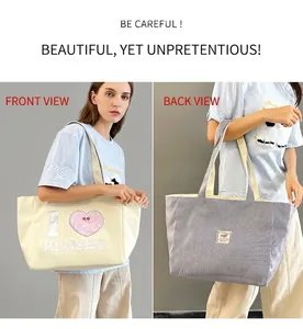 Dual-sided canvas tote bag showing white front with heart print and grey striped back design