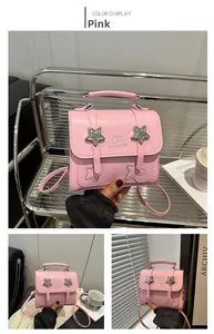 Pink crossbody bag with silver star detailing and metallic logo on textured faux leather