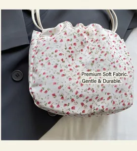 Close-up of floral fabric detail with drawstring closure on soft shoulder bag