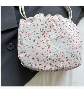 Close-up of floral fabric detail with drawstring closure on soft shoulder bag