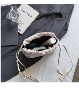 Detail view of floral fabric bucket bag showing spacious interior with black lining