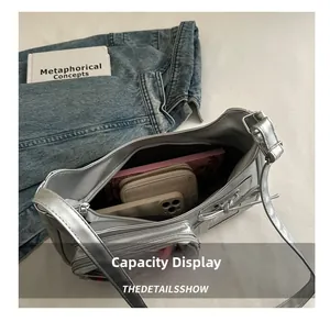 Silver leather crossbody bag interior showing spacious storage for wallet and phone