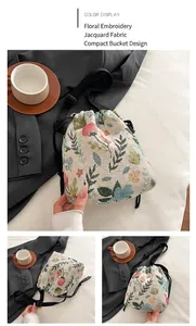 Detailed view of floral jacquard bucket bag featuring drawstring closure and black strap