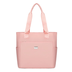 Pink waterproof nylon tote bag with silver logo plaque and functional side pockets