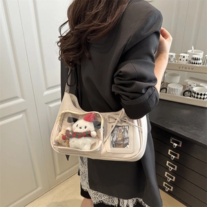 Sac ita en similicuir crème avec fenêtres transparentes et nœud porté à l'épaule
