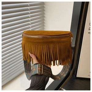 Close-up of brown suede tassel bag featuring a colorful ethnic woven adjustable strap