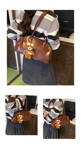Detail of dark brown vintage oil wax leather shoulder bag with cute teddy bear charm