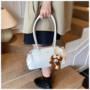 White vintage faux leather bag with embossed letters and cute puppy charm on stairs