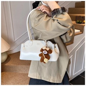 White oil wax leather shoulder bag with plush bear charm and embossed text detail