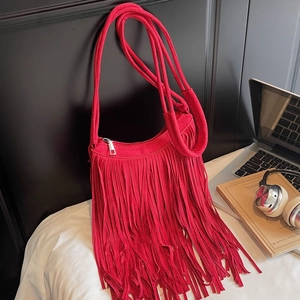Vibrant red faux suede crossbody bag featuring retro woven tassels and silver hardware accents