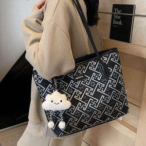 Ethnic tote bag with geometric patterns, black leather straps and cloud plush charm accessory