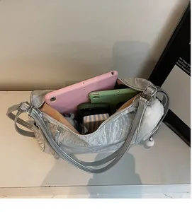 Silver metallic wrinkled tote showing large interior capacity for tablets and essentials