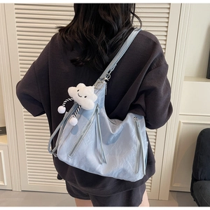 Light blue tote bag with pleated texture and a cute white cloud plush pendant accessory