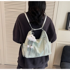 Back view of mint green wrinkled nylon backpack with a cute cloud plush pendant