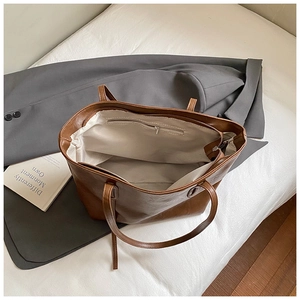 Top view of brown tote bag showing white fabric lining and inner zipper pocket