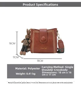 Brown bucket bag dimensions 18x16x11cm with ethnic strap and bunny charm detail