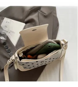 Detailed interior of polka dot shoulder bag showing space for phone and cosmetics