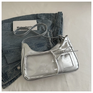 Close-up of metallic silver shoulder bag with clear PVC window and ribbon detail