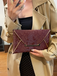 Deep burgundy envelope clutch bag with snakeskin texture and gold metal trim detail