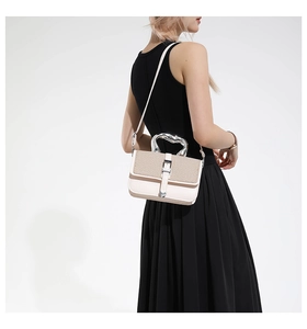 Detail of white leather and straw patchwork bag with unique silver mirror metal handle