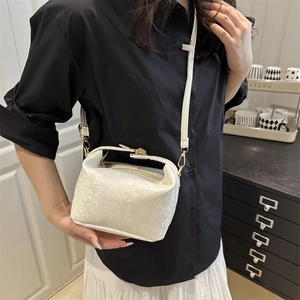White snakeskin textured mini crossbody bag for women with metallic clasp and strap