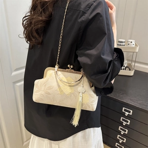 Elegant Chinese style brocade handbag with golden peony patterns and silk tassel detail