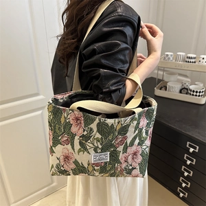 Floral jacquard canvas tote bag with pink flower pattern and wide shoulder straps