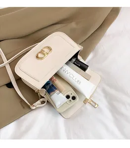 Detailed view of the off-white leather bag interior showing space for cosmetics and phone