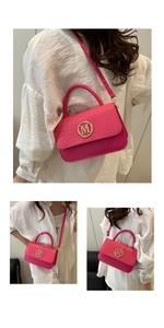 Detail of hot pink crossbody bag with crocodile texture flap and gold M logo buckle