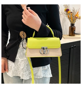 Detail of neon green leather flap crossbody bag with silver buckle and beige textured body