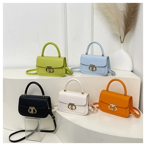 Five premium crossbody bags in assorted colors with golden metallic ring buckles on a display