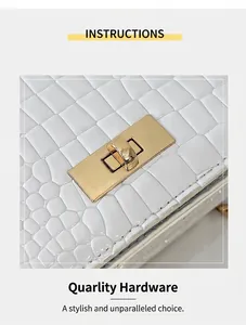 Detail of white stone-patterned handbag with luxury gold metal twist lock closure